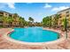 A large community pool surrounded by palm trees and lounge chairs providing a resort-style experience at 8601 Worldquest Blvd # B1/U3502, Orlando, FL 32821