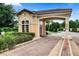 A welcoming brick-paved entry gate with a tile roof, creating a secure and stylish entrance at 8601 Worldquest Blvd # B1/U3502, Orlando, FL 32821