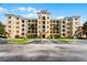 Four-story condominium building with balconies, shuttered windows, and well-maintained landscaping at 8601 Worldquest Blvd # B1/U3502, Orlando, FL 32821