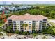 Exterior of the condominiums with lush palm trees and manicured landscape on a sunny day at 8601 Worldquest Blvd # B1/U3502, Orlando, FL 32821