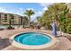 Community hot tub with ample seating, surrounded by lush tropical landscaping and lounge chairs at 8601 Worldquest Blvd # B1/U3502, Orlando, FL 32821