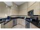 Kitchen featuring stainless steel appliances, ample cabinet space, and dark granite countertops at 8601 Worldquest Blvd # B1/U3502, Orlando, FL 32821