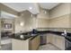 Kitchen featuring stainless steel appliances, breakfast bar, ample cabinet space, and dark granite countertops at 8601 Worldquest Blvd # B1/U3502, Orlando, FL 32821