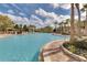Expansive pool with tropical landscaping and lounge chairs, offering a relaxing resort-style experience at 8601 Worldquest Blvd # B1/U3502, Orlando, FL 32821