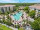 Aerial view of a large community pool surrounded by palm trees and lounge chairs at 8601 Worldquest Blvd # B1/U3502, Orlando, FL 32821