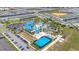 Community aerial view showcasing resort-style amenities including swimming pools, slides, a basketball court and manicured landscaping at 971 Paradise Dr, Davenport, FL 33897