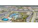 Expansive aerial view showcases the community's resort-style pool, clubhouse, and residential areas, highlighting the neighborhood layout at 971 Paradise Dr, Davenport, FL 33897