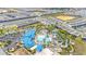 Community aerial view showcasing resort-style amenities including swimming pools, slides and more in a manicured neighborhood at 971 Paradise Dr, Davenport, FL 33897