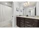 Bathroom showcasing double sinks with granite countertop, neutral tile, and bathtub at 971 Paradise Dr, Davenport, FL 33897