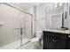 Bright bathroom features a glass enclosed shower, granite vanity, and a modern toilet at 971 Paradise Dr, Davenport, FL 33897