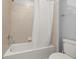 Bright bathroom featuring a shower/tub combo, tiled walls, and neutral tones at 971 Paradise Dr, Davenport, FL 33897