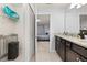 Well-lit bathroom featuring a closet, modern fixtures, and a decorative vanity at 971 Paradise Dr, Davenport, FL 33897