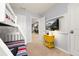 Bright bedroom showcasing a bunk bed, yellow nightstand, and mounted TV for entertainment at 971 Paradise Dr, Davenport, FL 33897