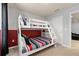 Cozy bedroom featuring a bunk bed, polka dot accent wall, and neutral carpet at 971 Paradise Dr, Davenport, FL 33897