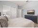 Bright bedroom featuring a plush bed, modern dresser, and a large closet offering ample storage space at 971 Paradise Dr, Davenport, FL 33897
