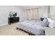 Inviting bedroom with a large bed, carpet flooring, and an entertainment center at 971 Paradise Dr, Davenport, FL 33897