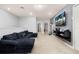 Spacious bonus room offering a large couch, big screen tv, and versatile space for entertainment and relaxation at 971 Paradise Dr, Davenport, FL 33897