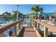 Inviting community center and pool area, accessed by a wooden bridge, set against a backdrop of swaying palms at 971 Paradise Dr, Davenport, FL 33897