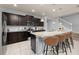 Charming kitchen with stainless steel appliances, granite countertops, and a cozy breakfast bar at 971 Paradise Dr, Davenport, FL 33897