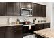 Close-up of a modern kitchen with stainless steel appliances and elegant granite countertops at 971 Paradise Dr, Davenport, FL 33897