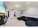 Spacious living room featuring plush sectional sofa, mounted TV, and ample natural light at 971 Paradise Dr, Davenport, FL 33897