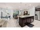 Open-concept kitchen and living space with modern appliances, granite countertops, and comfortable seating at 971 Paradise Dr, Davenport, FL 33897