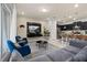 Cozy living room featuring modern decor, a stylish sofa, and an open-concept design with the kitchen at 971 Paradise Dr, Davenport, FL 33897