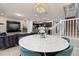 Open-concept living space seamlessly connects the dining area, living room, kitchen, and stairway at 971 Paradise Dr, Davenport, FL 33897