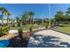 An outdoor mini golf course featuring synthetic turf, palm trees, lush landscaping, and decorative lighting at 971 Paradise Dr, Davenport, FL 33897