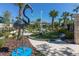 Well-manicured mini-golf course surrounded by landscaping with tropical palms at 971 Paradise Dr, Davenport, FL 33897