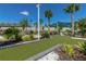 A manicured mini golf course with synthetic turf, decorative stones, palms, and lush greenery offers leisure and recreation at 971 Paradise Dr, Davenport, FL 33897