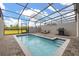 Private screened pool with brick patio, lounge chairs and a BBQ grill at 971 Paradise Dr, Davenport, FL 33897