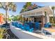 Charming outdoor pool bar with bright blue seating, creating a vibrant and inviting space for refreshments at 971 Paradise Dr, Davenport, FL 33897