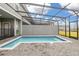 Private screened pool area with brick patio and views of the neighborhood at 971 Paradise Dr, Davenport, FL 33897