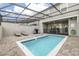 Private screened pool with brick patio, lounge chairs and a BBQ grill at 971 Paradise Dr, Davenport, FL 33897