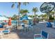 Inviting poolside dining area with blue chairs and tables under palm trees, next to the Blue Marlin Grille sign at 971 Paradise Dr, Davenport, FL 33897