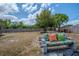 Enjoy outdoor living on this backyard bench with colorful pillows and a partially-fenced yard at 987 Trumbull St, Deltona, FL 32725