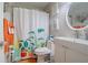 Bathroom featuring a modern vanity, round mirror, and a shower with a botanical patterned curtain at 987 Trumbull St, Deltona, FL 32725