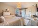 This primary bedroom features a woven pendant light, sliding barn door, and neutral décor at 987 Trumbull St, Deltona, FL 32725