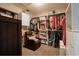 Walk-in closet with custom shelving, hanging racks, and comfortable seating at 987 Trumbull St, Deltona, FL 32725