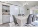 Elegant dining room featuring a stylish table, unique light fixtures, and sliding barn door at 987 Trumbull St, Deltona, FL 32725
