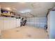 Spacious garage with storage cabinets, overhead lighting, and an automatic door at 987 Trumbull St, Deltona, FL 32725