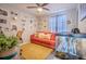 Home office features a futon, eclectic gallery wall, and unique decorations at 987 Trumbull St, Deltona, FL 32725