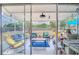 Bright sunroom with comfortable seating, overhead lighting, and access to the backyard at 987 Trumbull St, Deltona, FL 32725
