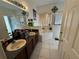 Well-lit bathroom featuring double sinks, a bathtub, and a separate shower, creating a relaxing space at 1029 Dampierre Ct, Kissimmee, FL 34759