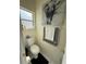 Bathroom featuring a toilet, decorative towels, and art above the toilet, adding character to the space at 1029 Dampierre Ct, Kissimmee, FL 34759