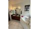 Bathroom featuring double sinks, a soaking tub, and a decorative elephant print at 1029 Dampierre Ct, Kissimmee, FL 34759