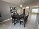 Dining room with modern light fixture, stylish wall decor, and tile flooring at 1029 Dampierre Ct, Kissimmee, FL 34759
