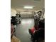 Cluttered garage with jetski, tools, tires, and ample room for storage and vehicles at 1029 Dampierre Ct, Kissimmee, FL 34759