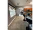 Bright kitchen features a tile floor, wooden cabinets, and a view into the dining area at 1029 Dampierre Ct, Kissimmee, FL 34759
